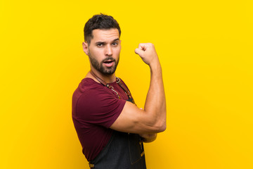 Barber man in an apron making strong gesture