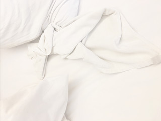 wrinkle messy blanket in bedroom after waking up in the morning, from sleeping in a long night, details of duvet and blanket, an unmade bed in hotel bedroom with white blanket