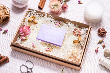 Obraz na płótnie Canvas Natural homemade soap in cardboard box on wooden table