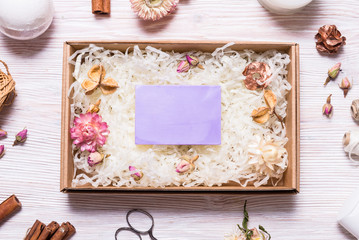 Natural homemade soap in cardboard box on wooden table