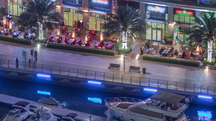 Fototapeta na wymiar Waterfront promenade in Dubai Marina aerial night timelapse. Dubai, United Arab Emirates