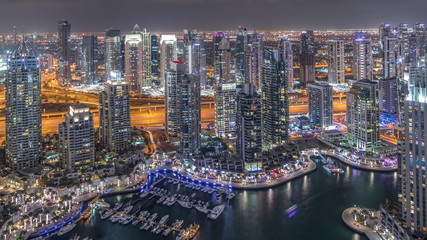 Plakat Dubai Marina skyscrapers and jumeirah lake towers view from the top aerial night timelapse in the United Arab Emirates.