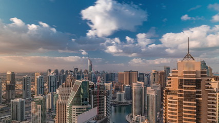Obraz premium Dubai Marina skyscrapers and jumeirah lake towers view from the top aerial timelapse in the United Arab Emirates.