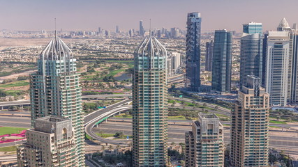 Fototapeta premium Dubai Marina skyscrapers and jumeirah lake towers view from the top aerial timelapse in the United Arab Emirates.
