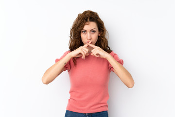 Young pretty woman over isolated background showing a sign of silence gesture