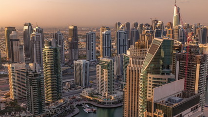 Dubai Marina skyscrapers and jumeirah lake towers sunrise view from the top aerial timelapse in the United Arab Emirates.