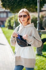 Blonde model girl with waist bag 