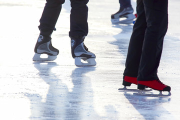 feet in skates on an ice rink. Sport and entertainment. Rest and winter holidays.