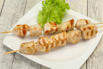 Grilled pork skewer served salad