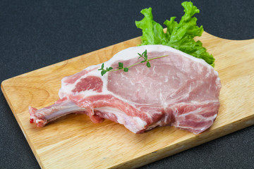 Raw pork bone steak over wooden