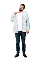Naklejka premium Full-length shot of Handsome man with beard with tired and sick expression over isolated white background