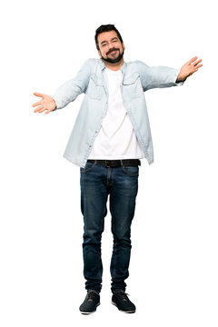 Full-length shot of Handsome man with beard presenting and inviting to come with hand over isolated white background