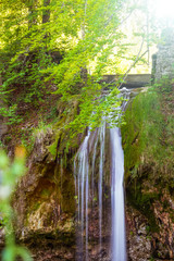 Smooth waterfall in the forest on mountain