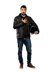 Full-length shot of Biker man surprised and shocked while looking right over isolated white background