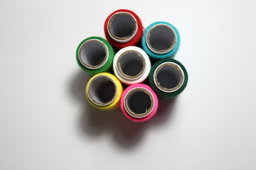 Sewing cotton line on white background. Space for copy, insert text. Metaphor with political position, teamwork, feelings, emotions, decision. 