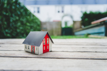 Obraz na płótnie Canvas New home and house concept: Red house model outdoors