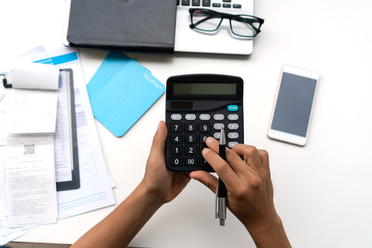 Man using calculator with doing finance at home office.