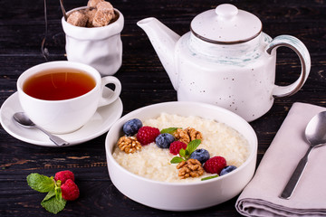Rice porridge with fresh berries and walnuts