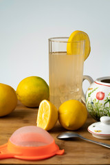 Lemonade with ice, yellow lemons and sugar, on white background