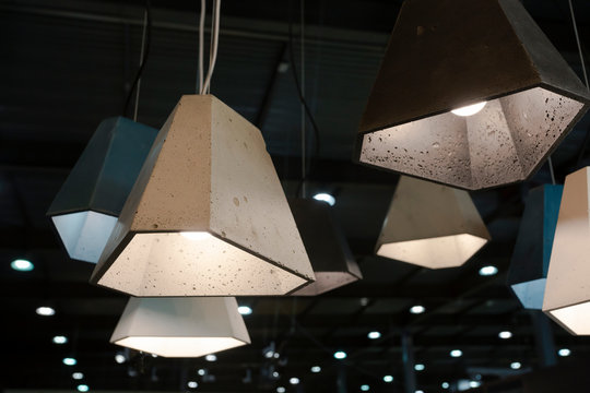 Statement pendant lapms with concrete plafonds hanging from the ceiling - good example of contemporary swedish scandinavian minimalistic interior decor