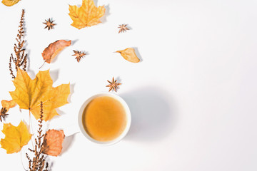 Obraz na płótnie Canvas Autumn or Winter composition with dried autumn leaves, coffee cup pine and and anise stars. Flat lay, top view.