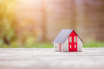 Obraz na płótnie Canvas New home and house concept: Red house model outdoors