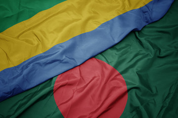 waving colorful flag of bangladesh and national flag of gabon.