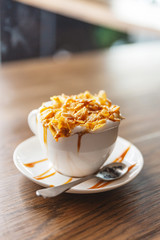 Hot cappuccino topping with corn flakes cereal and caramel butterscotch.