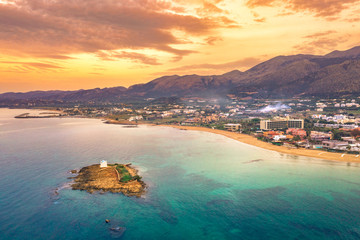 An old white church in a small island at sunset in Malia, Crete, Greece. - obrazy, fototapety, plakaty