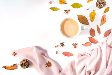 Autumn or Winter concept with pine and maple leaves, coffee cup , cinnamon, and scarf, Flat lay, top view.