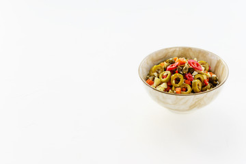 Olive salad for muffuletta in a bowl on a white table.