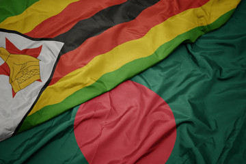 waving colorful flag of bangladesh and national flag of zimbabwe.