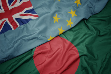 waving colorful flag of bangladesh and national flag of Tuvalu .