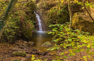 Smooth waterfall in the forest on mountain