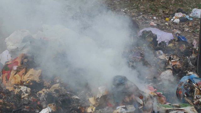 burning garbage near residential buildings. ecology is in danger. Environmental pollution concept.