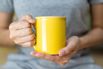 Warm Fresh Drink,Two Hand hold yellow ceramic mug
