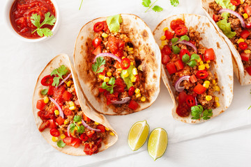 mexican beef and pork tacos with salsa, guacamole and vegetables