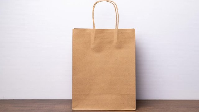 4K Stop motion of shopping paper bag with brown red green and black.