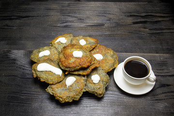 coffee with a mug next to potato pancakes, top view. Selective focus. Blur background