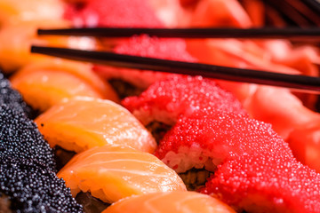 Various kinds of sushi served on a dark background