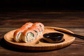 Various kinds of sushi served on a dark background