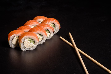 Various kinds of sushi served on a dark background