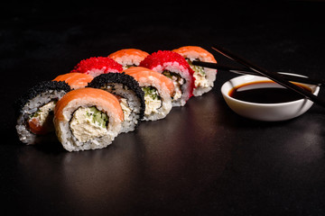 Various kinds of sushi served on a dark background