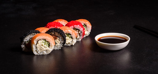 Various kinds of sushi served on a dark background