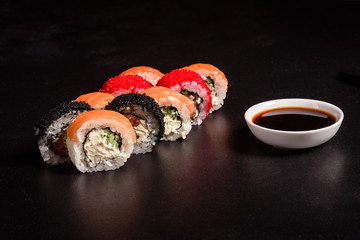 Various kinds of sushi served on a dark background