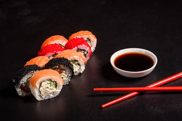 Various kinds of sushi served on a dark background