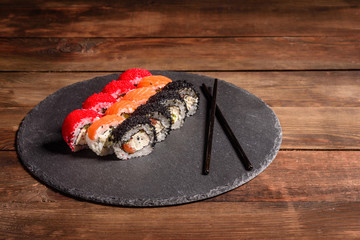 Various kinds of sushi served on a dark background