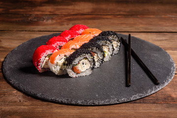 Various kinds of sushi served on a dark background