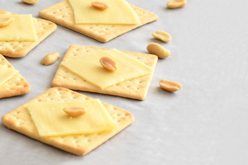 Crackers with cheese and peanuts with copy space. Selective focus.