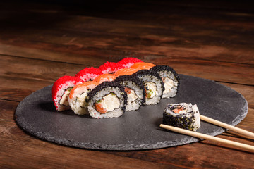 Various kinds of sushi served on a dark background